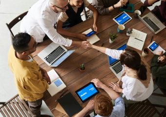 Overhead shot of a diverse team collaborating in a modern office meeting.
